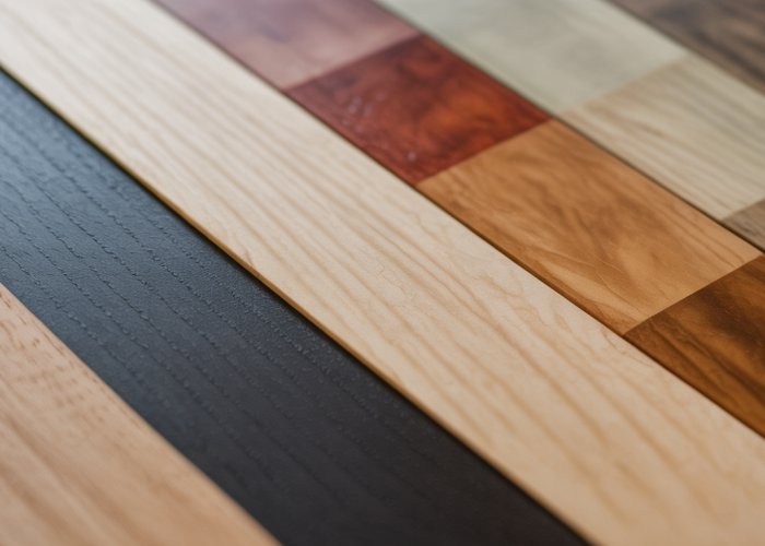 Ash wood samples with various wood stain colors showcasing grain definition.