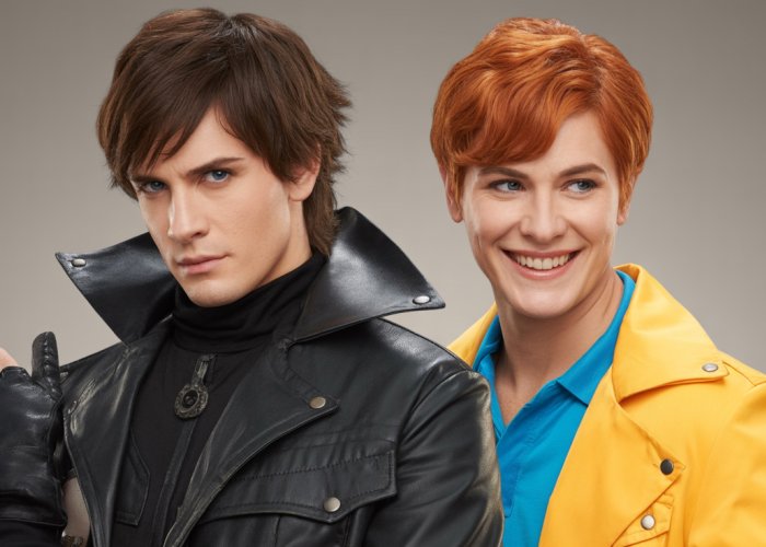 Two people with opposite personalities, one dressed in dark clothing and looking serious, the other in bright clothing and smiling.