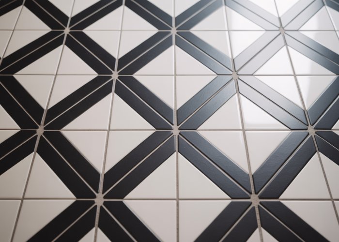 Diagonal black and white tile pattern on a bathroom floor.