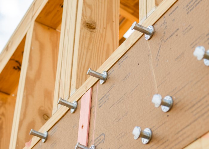 Exterior wall sheathing being installed on new house construction.