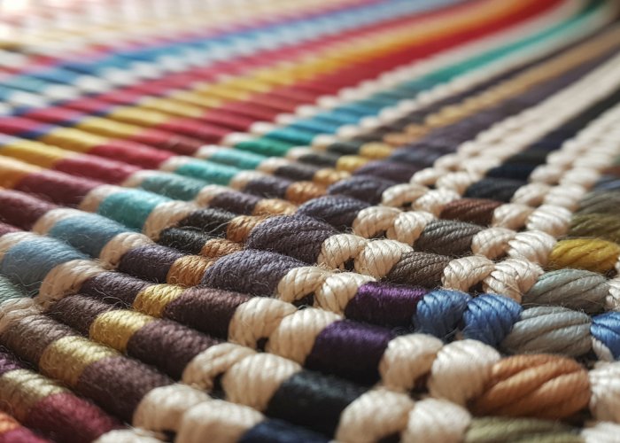 Close-up of handwoven fabric showcasing the weft and weave patterns.