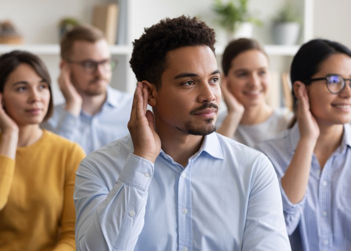 People of diverse ages and backgrounds engaging in conversation, highlighting the role of normal hearing in everyday life.