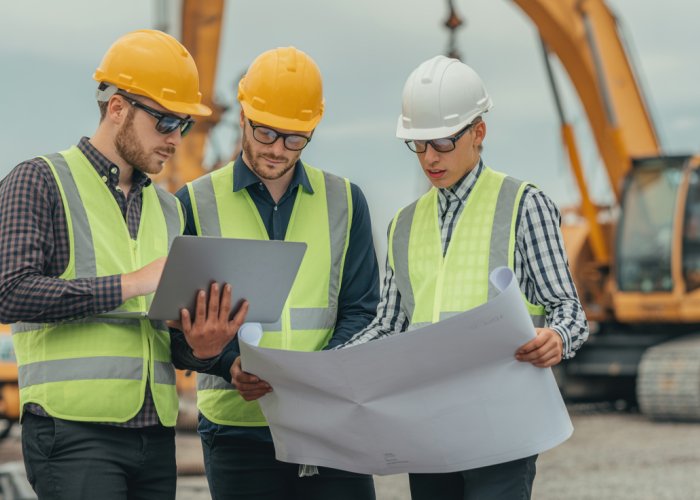 Cost Estimators using PMP Parametric Estimating techniques on a construction site.