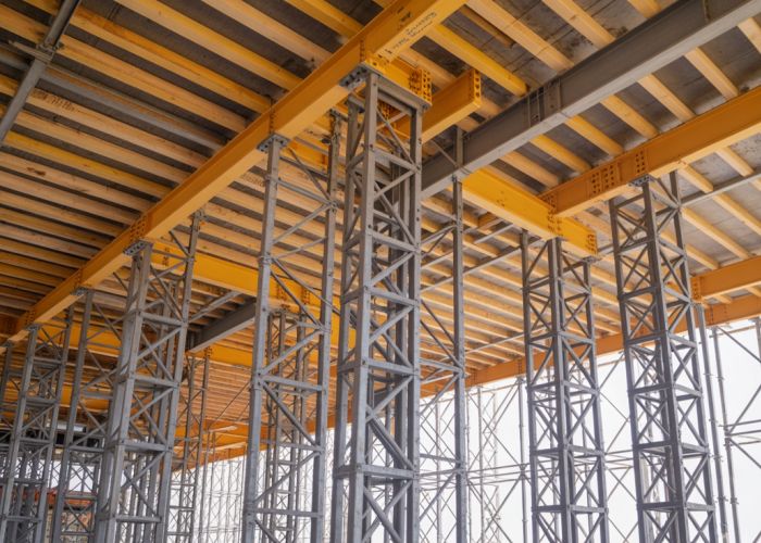 Steel girders and wooden joists create the framework for a new building.
