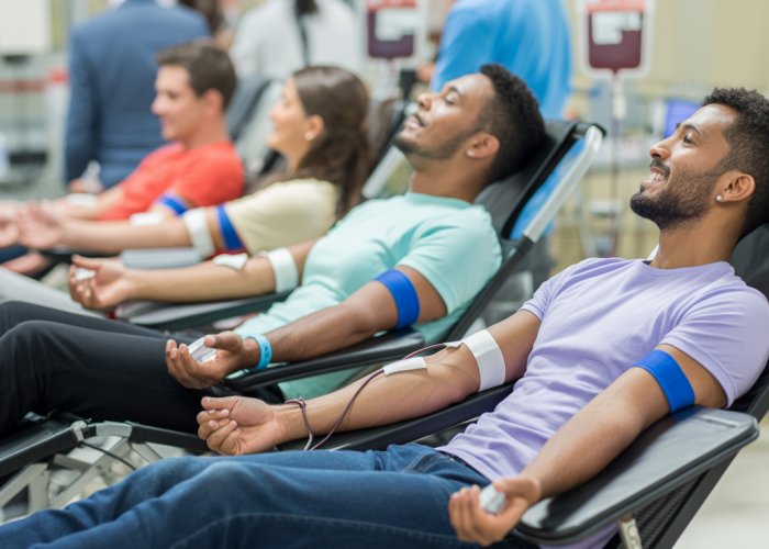 People donating blood, highlighting the need for Type O blood donors.