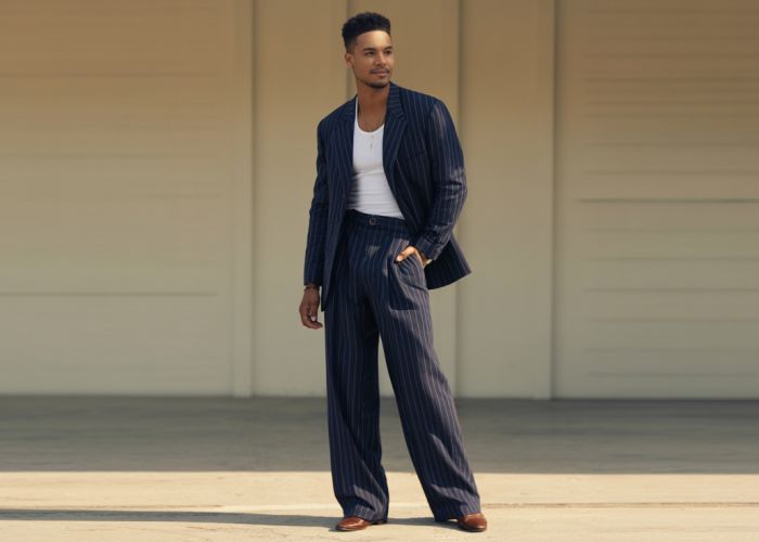 Wisdom Kaye, stylishly dressed, standing tall and showcasing his height.