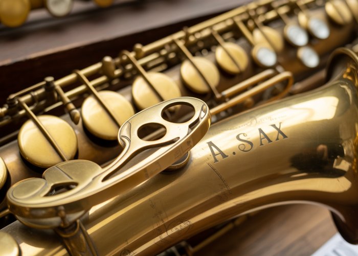 Antique saxophone invented by Adolphe Sax, highlighting intricate keywork.
