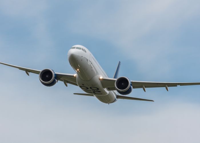 Passenger jet exhibiting a dutch roll maneuver in flight, with blurred wingtips showing the oscillating motion.