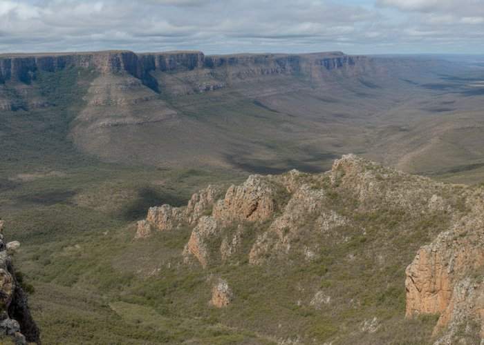 Aerial view of the Barberton Greenstone Belt, a UNESCO World Heritage Site, showing diverse rock formations and sparse vegetation.