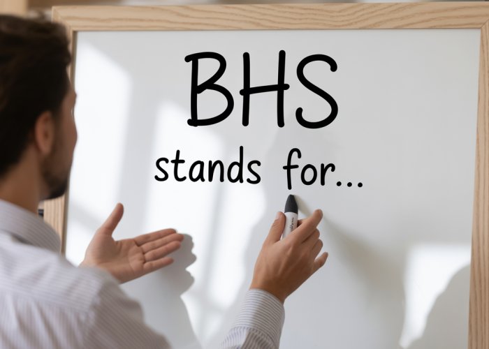 Friendly person explaining what BHS stands for on a whiteboard.