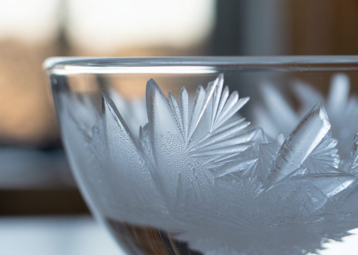 Frozen vinegar crystals forming intricate patterns.