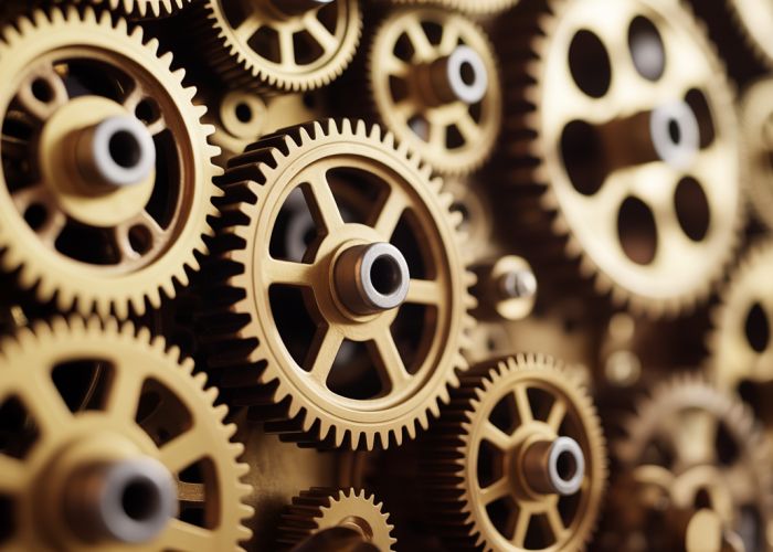 Intricate arrangement of interlocking brass gears and pulleys.