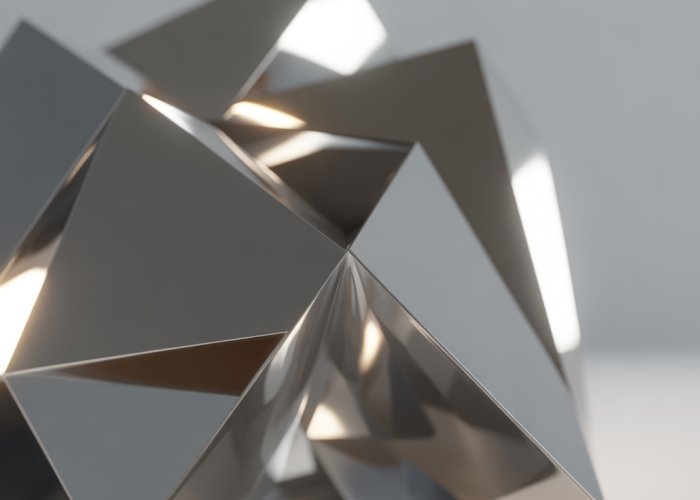 Intricate geometric steel sculpture reflecting light.
