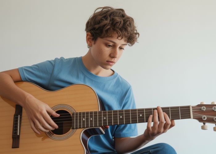 A beginner tentatively learning to play the guitar, showcasing the novice phase of skill acquisition.