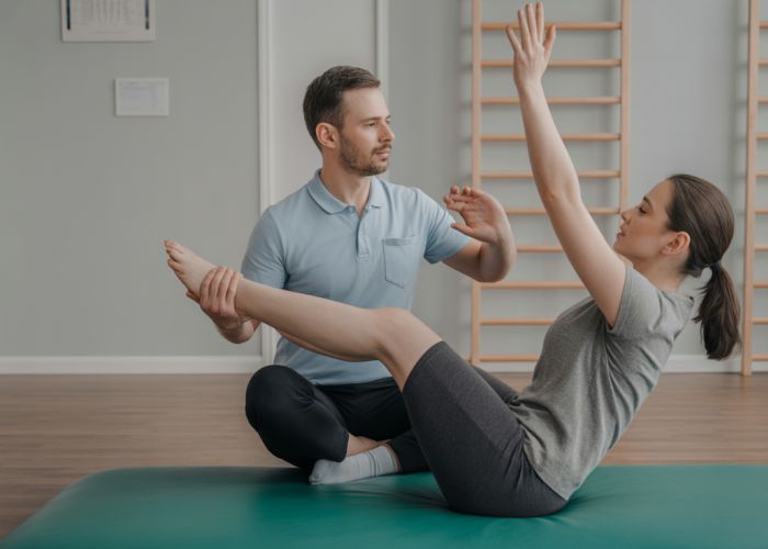 Physical therapist helping a patient perform gentle stretches for resting tone contractions in their arm.