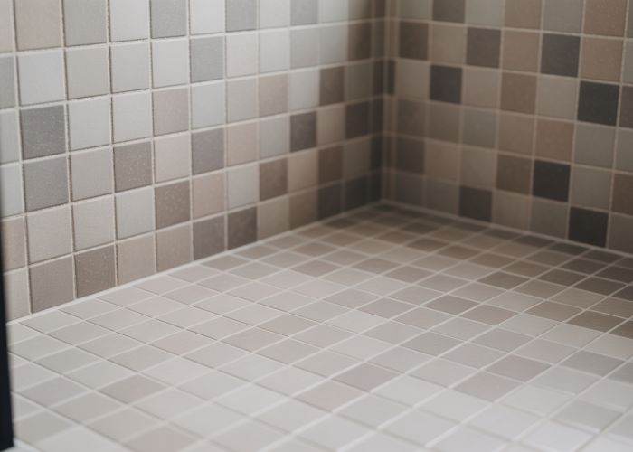 Perfectly tiled internal corner in a bathroom, showcasing precision grout lines and seamless tile fit.