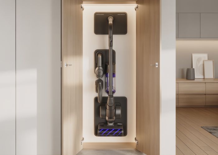 Wall-mounted cordless vacuum cleaner installed in a modern home utility closet, showcasing its space-saving design and organized attachments.